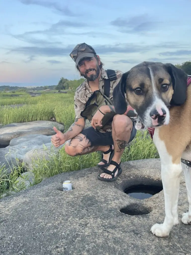 A man and his dog outside.
